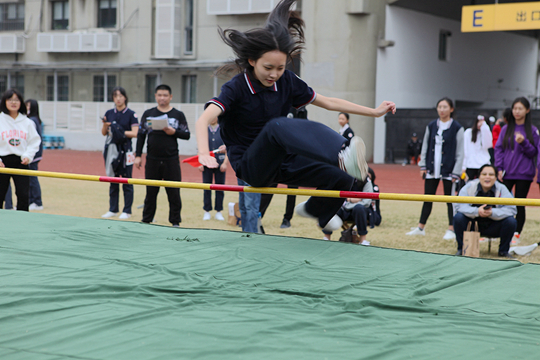 田赛场上，选手们飞腾跳越，尽显风采，灵活的身段在空中划出一道道优美弧线